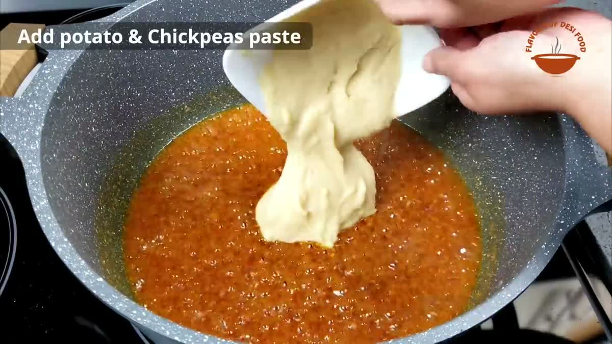 Adding potato and chickpea paste to the masala